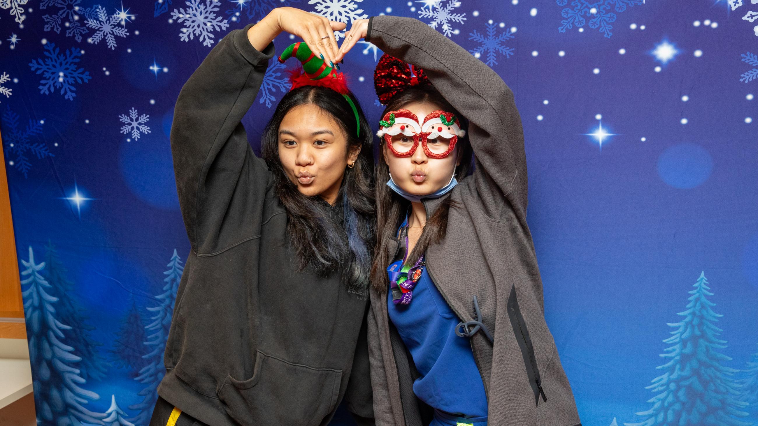 Staff members pose at the photo booth during Sinai Health’s Holiday Open House.