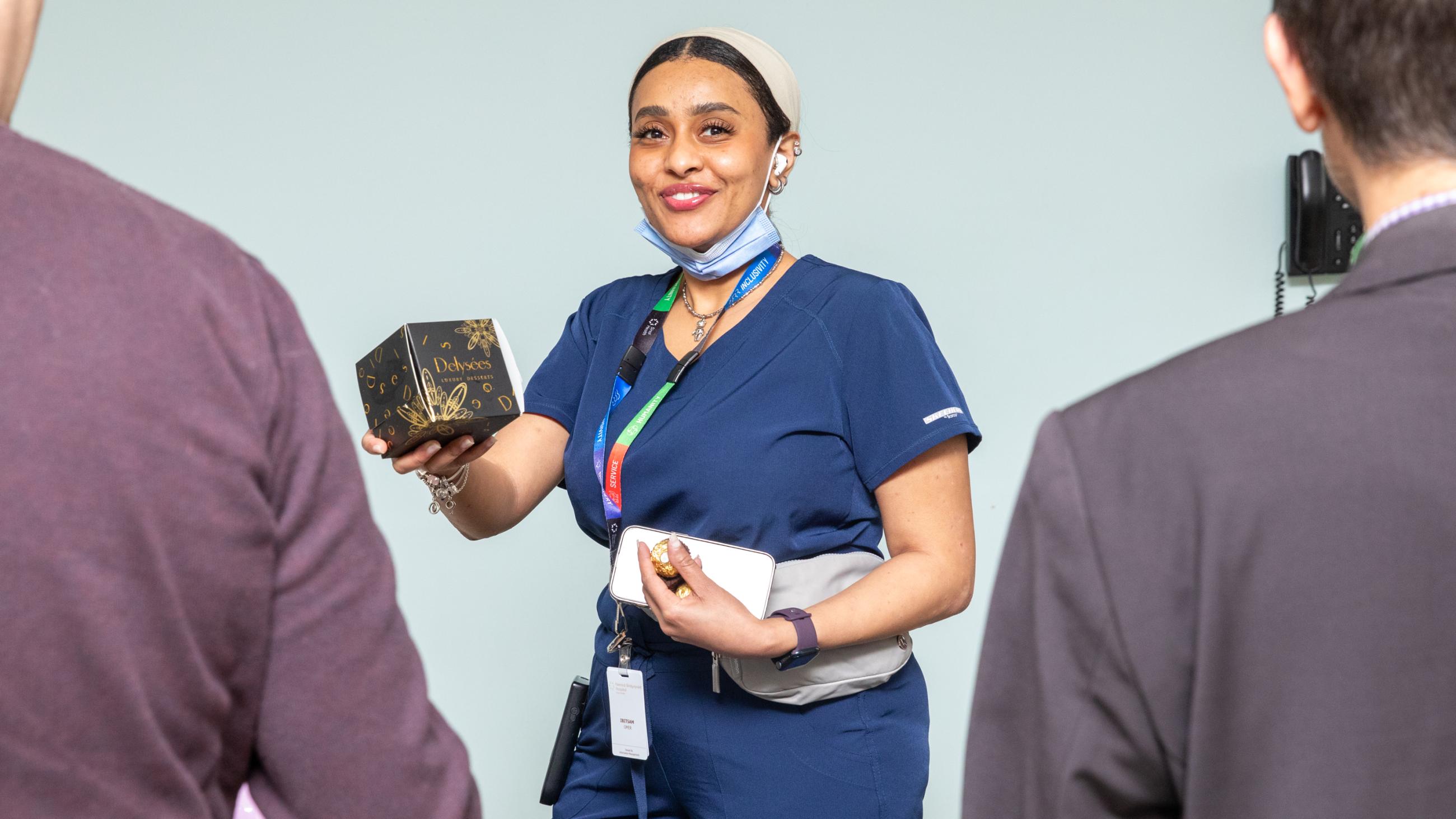 A staff member receives a holiday treat at Sinai Health’s Holiday Open House.