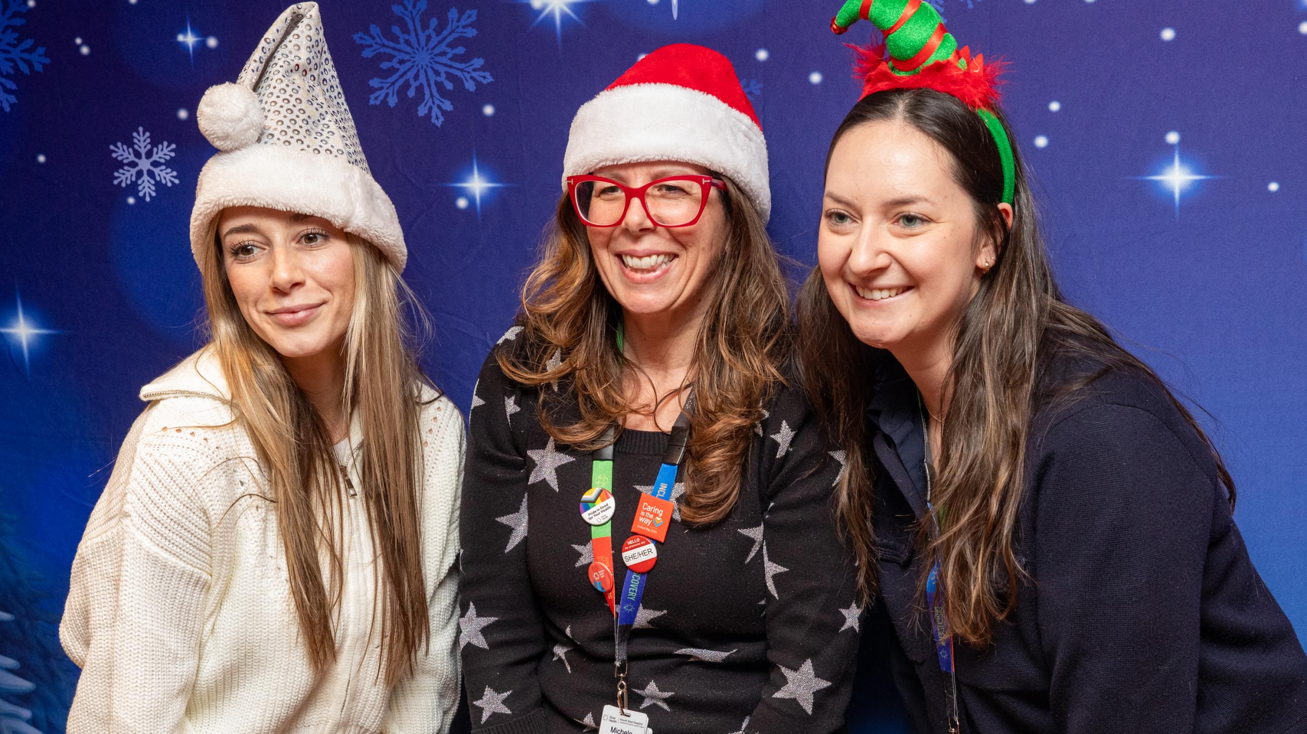 Staff members pose at the photo booth during Sinai Health’s Holiday Open House.