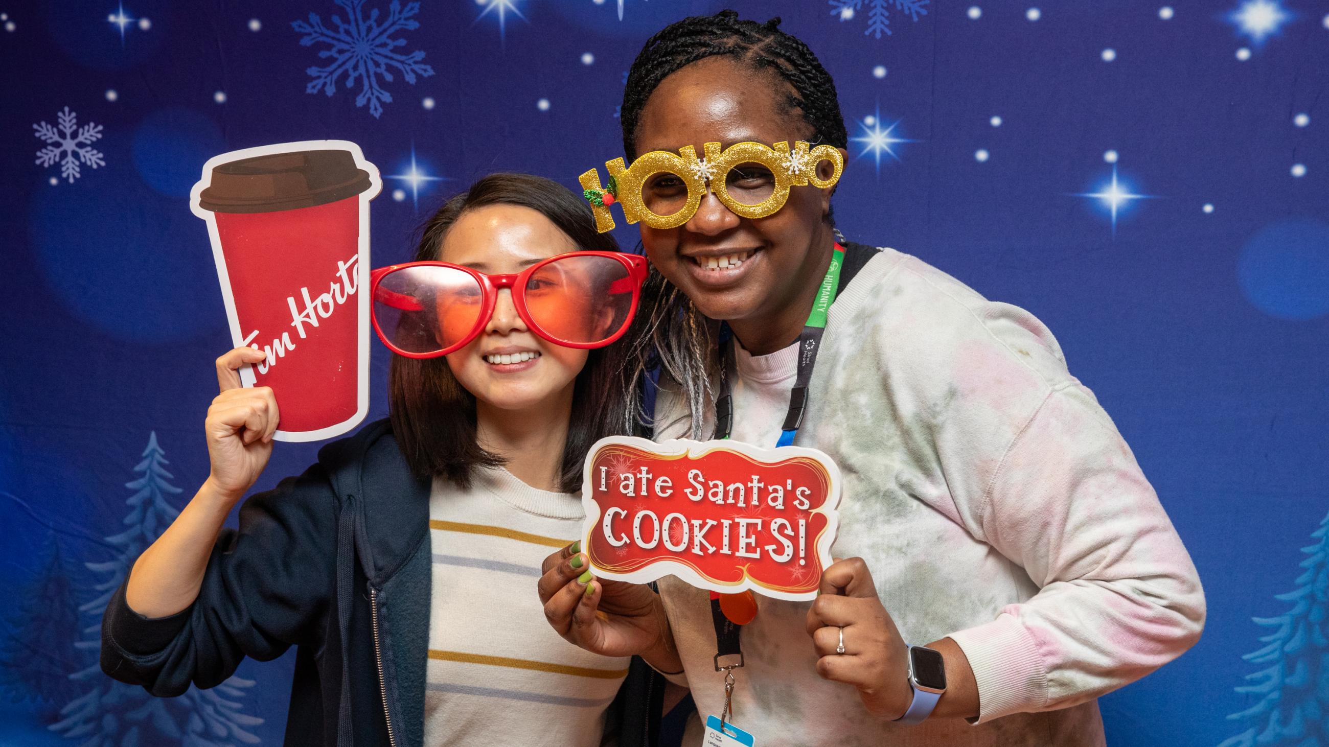 Staff members pose at the photo booth during Sinai Health’s Holiday Open House.