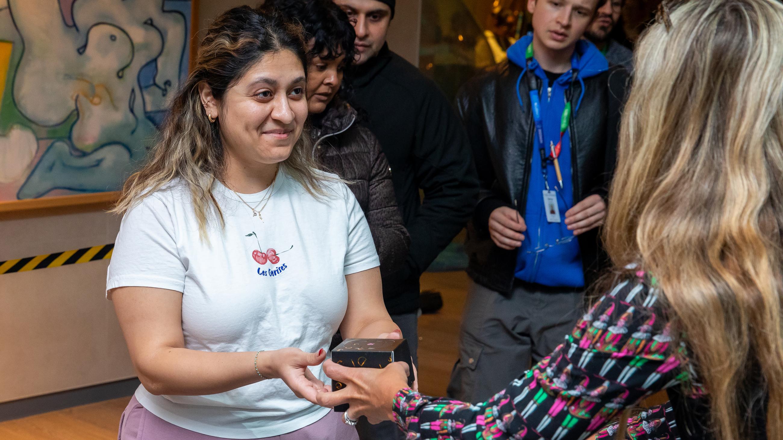 A staff member receives a holiday treat at Sinai Health’s Holiday Open House.