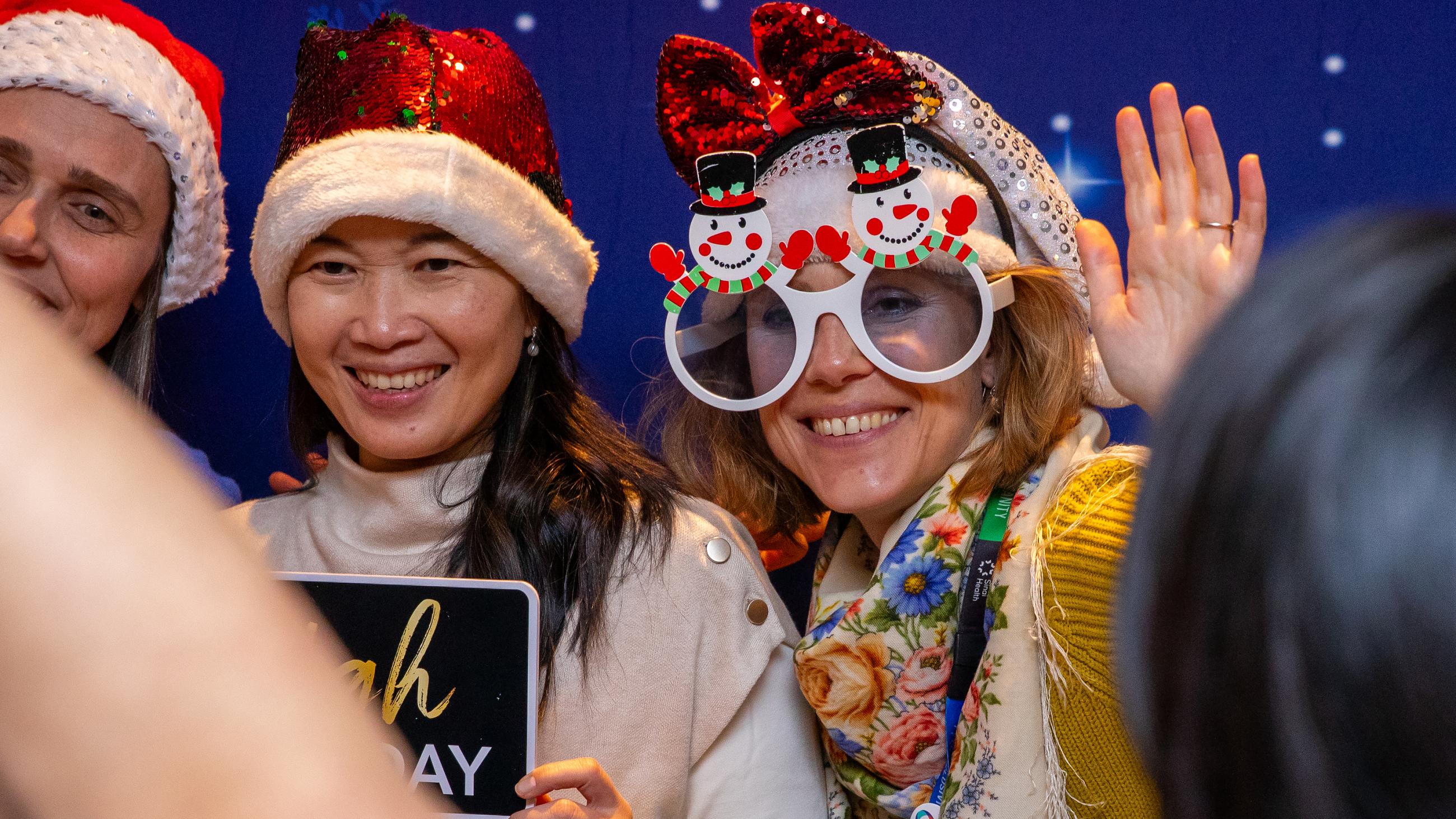 Staff members pose at the photo booth during Sinai Health’s Holiday Open House.