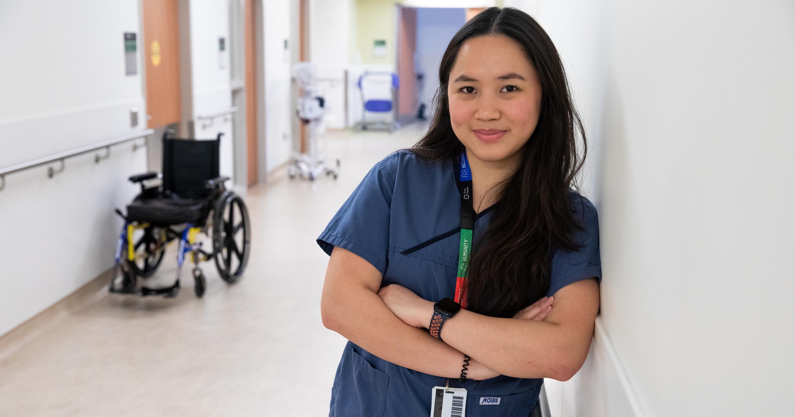 A Registered Practical Nurse from Sinai Health’s Hennick Bridgepoint Hospital poses for a headshot in a hallway on the 3North Unit.