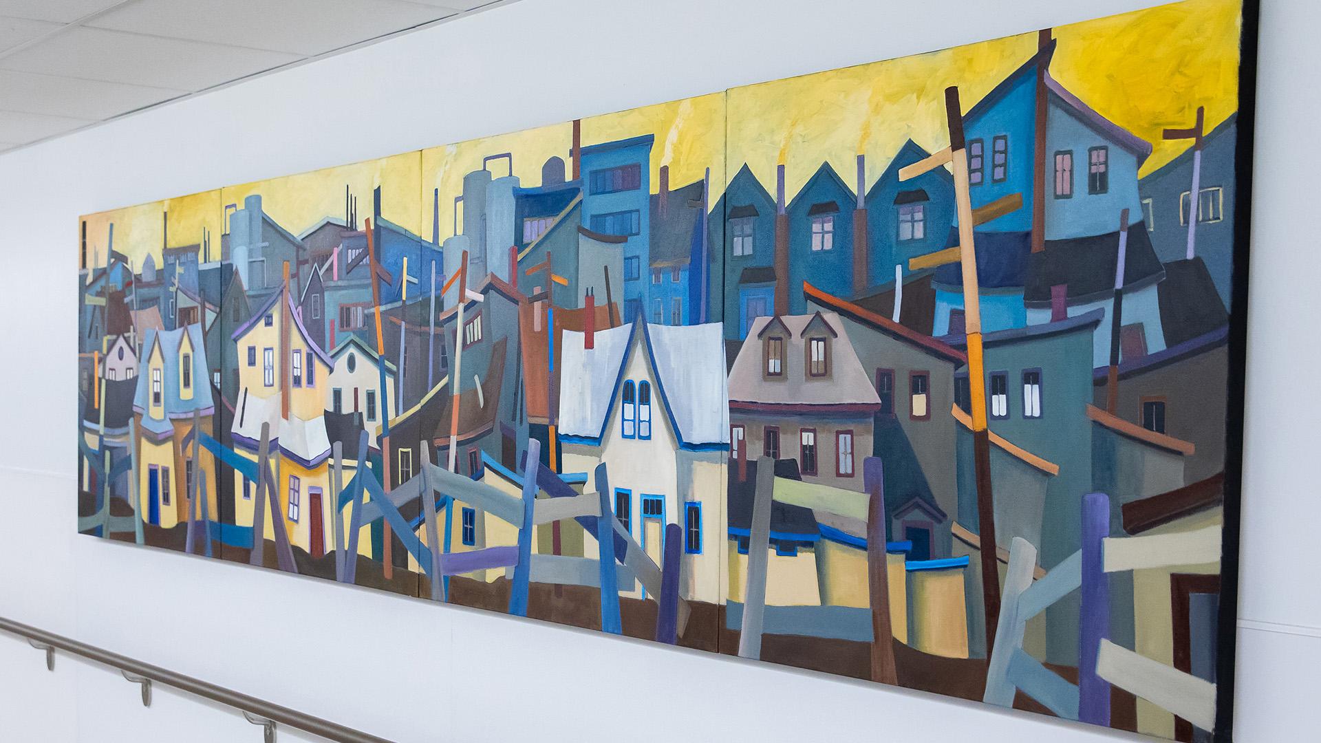 A vibrant mural in a hallway in Sinai Health’s Cancer Care Clinic depicts Canada’s east coast buildings.