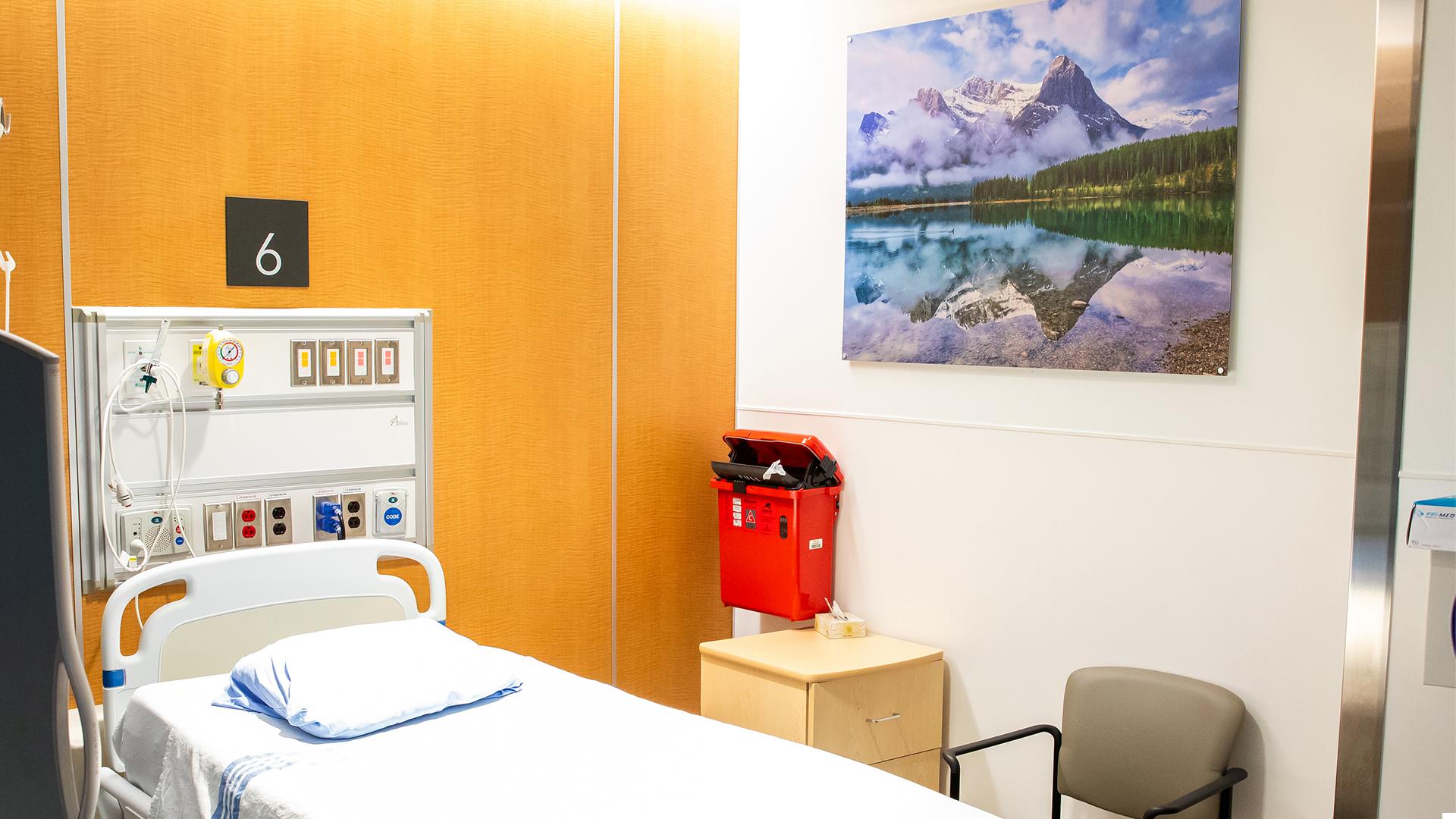 An empty exam room in Sinai Health’s Cancer Care Clinic is decorated with a painting that shows the Canadian Rockies.