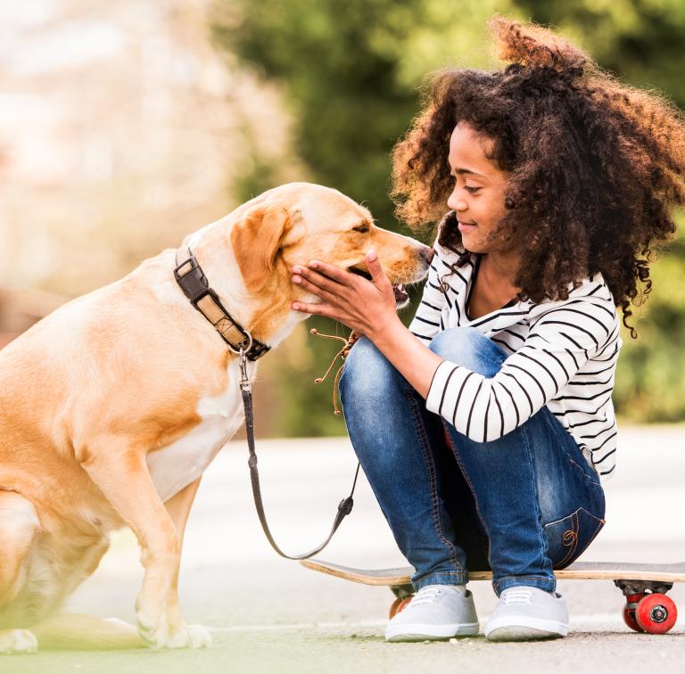 young girl petting dog