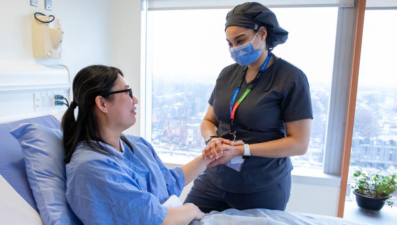 Nurse holding a patient's hand in comfort