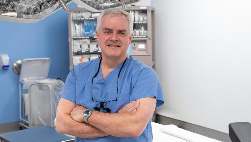 A photo of Dr. Ian Witterick, Sinai Health's surgeon-in-chief in a medical setting with this arms crossed 