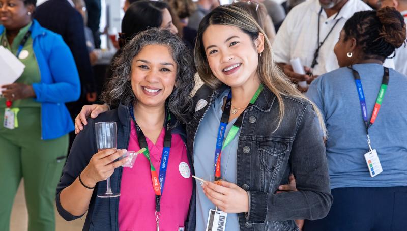 Two staff members at a celebration ceremony