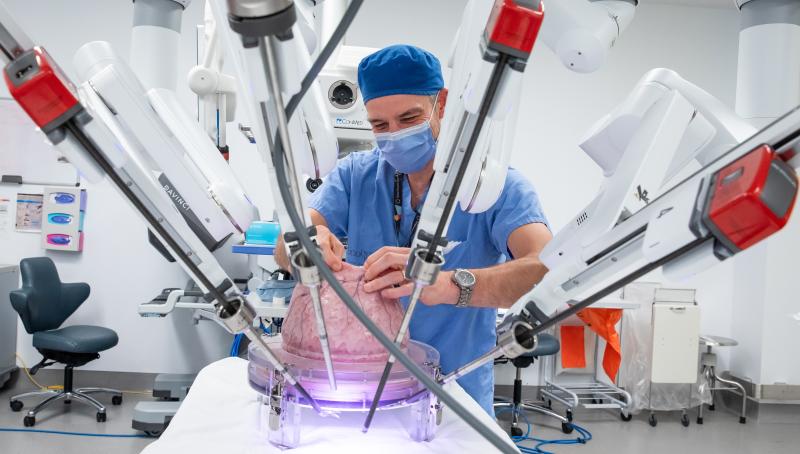 Surgeon in surgery room with robotics 