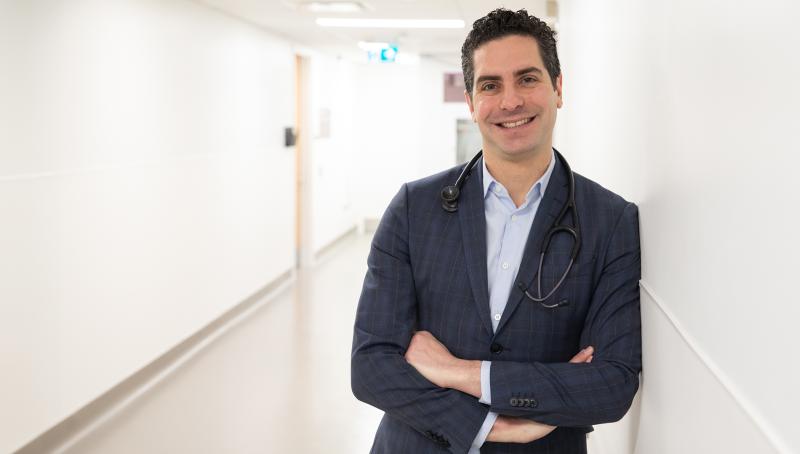 Dr. Nathan Stall in a blue suit and stethoscope.