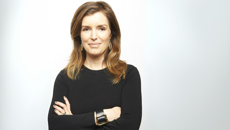 woman wearing black shirt stands with crossed arms