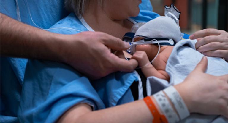 A woman holding her newborn baby