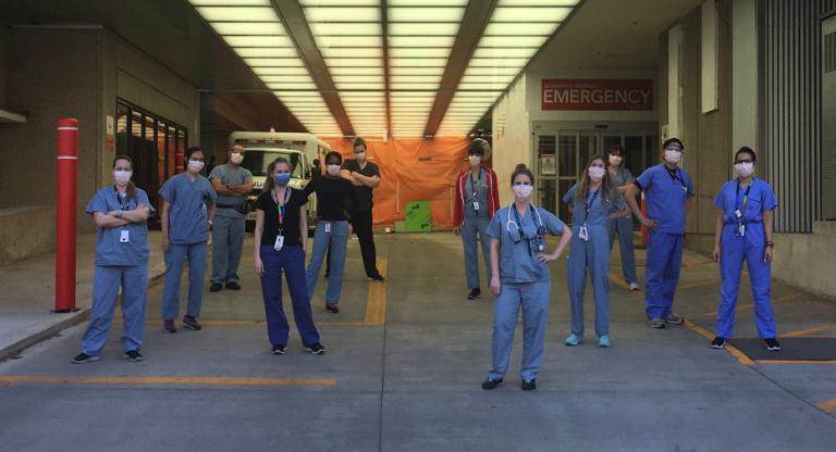 COVID-19 frontline staff stand in front of the Emergency Department