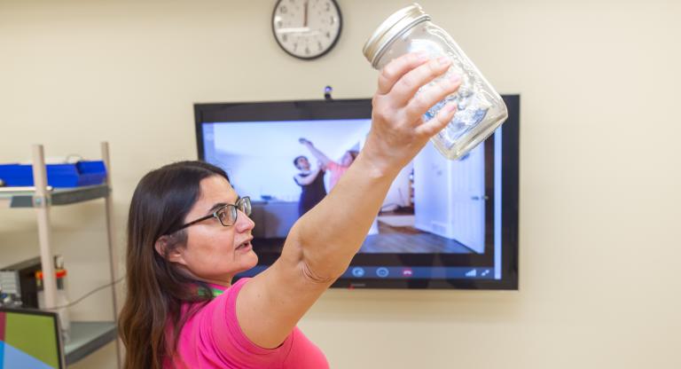 a physiotherapist taking a virtual rehab session