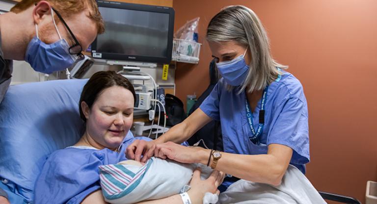 Mother and baby receiving care from a healthcare professional