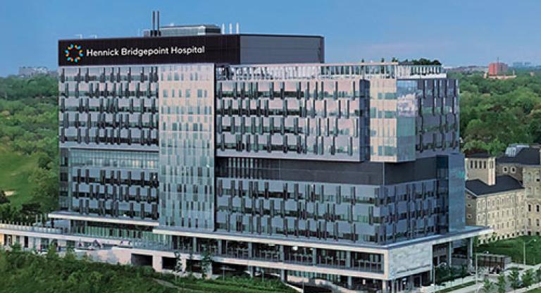 Long shot of modern looking hospital building with Hennick Bridgepoint Hospital sign.