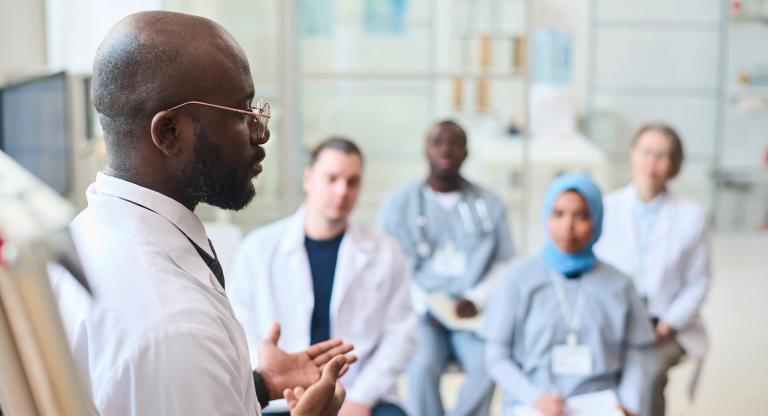 A physician presents a case to four other health-care providers