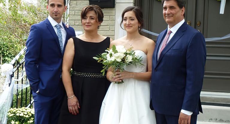 family standing with bride