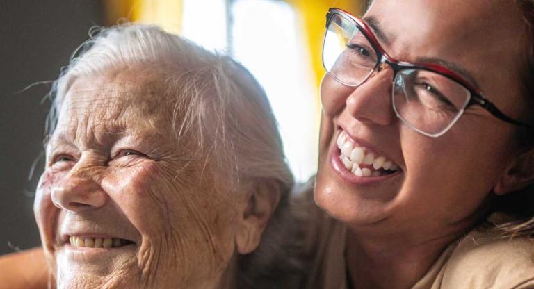 young woman sits behind older women