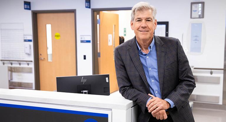 Dr. Bjug Borgundvaag in a blue dress shirt and blazer at the emergency department. 