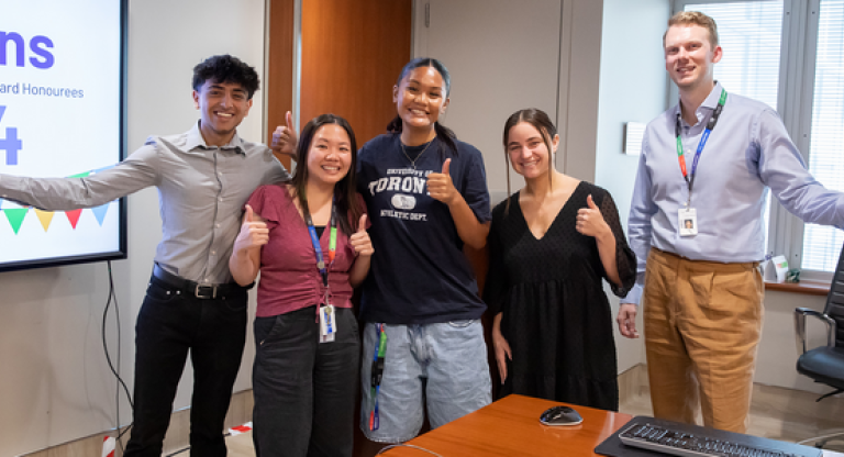 group photo of five people in a office