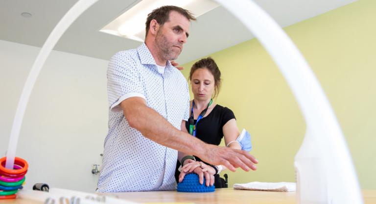 physiotherapist helping patient