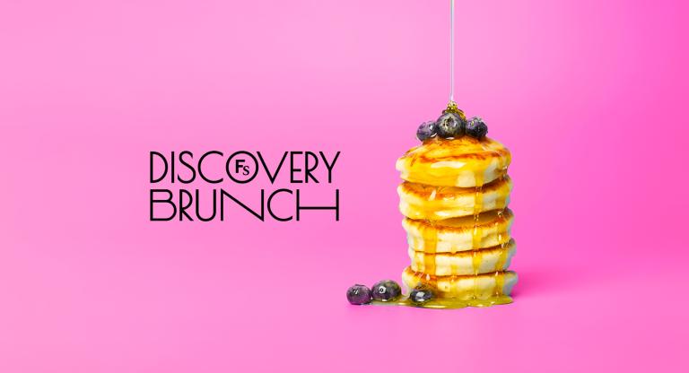 Logo that says discovery brunch next to a stack of pancakes on a bright pink background