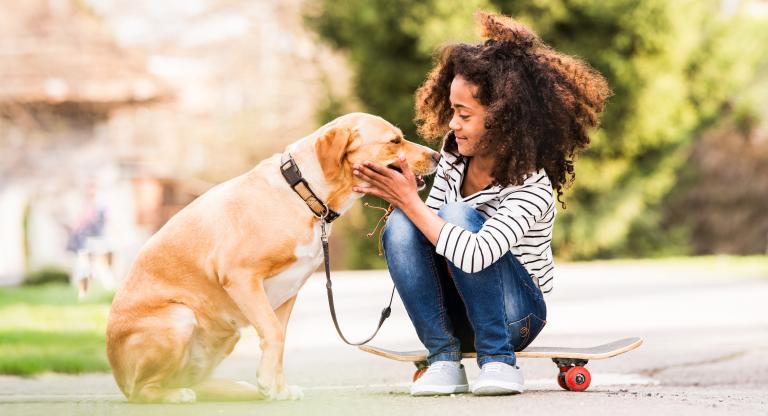 young girl petting dog