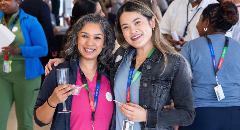 Two staff members at a celebration ceremony