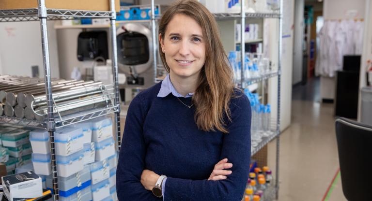 A photo of Diane Haakonsen posing inside of a lab 