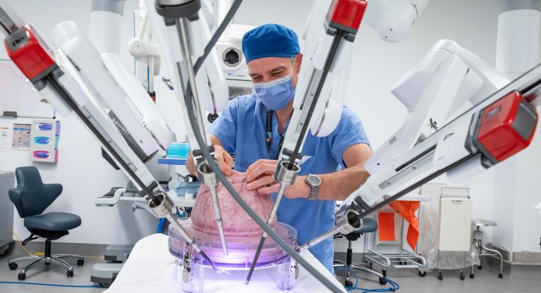 Surgeon in surgery room with robotics 