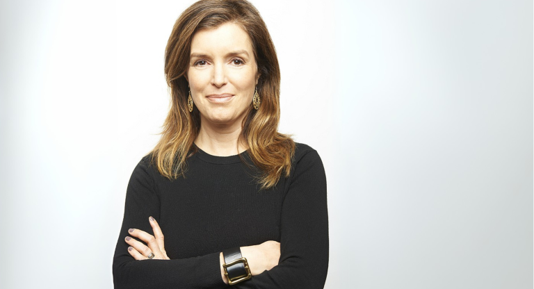 woman wearing black shirt stands with crossed arms