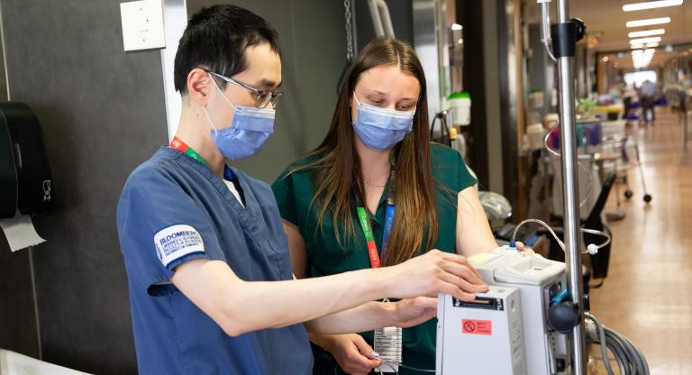 Two medical professionals checking equipment 