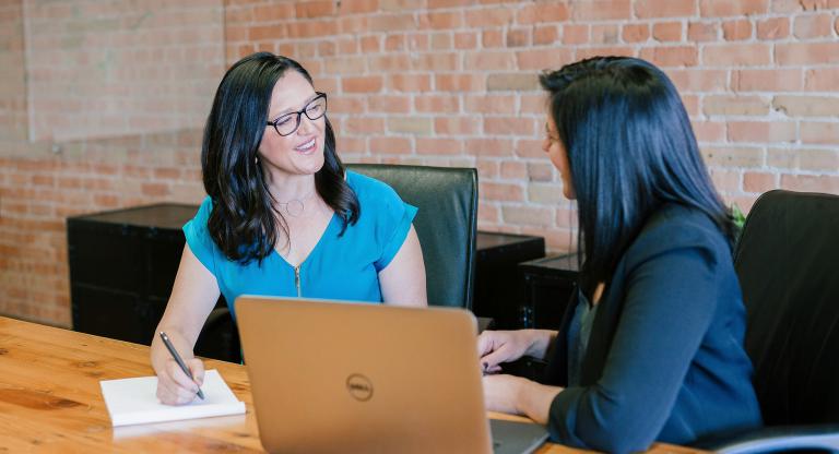 Two women holding a meeting