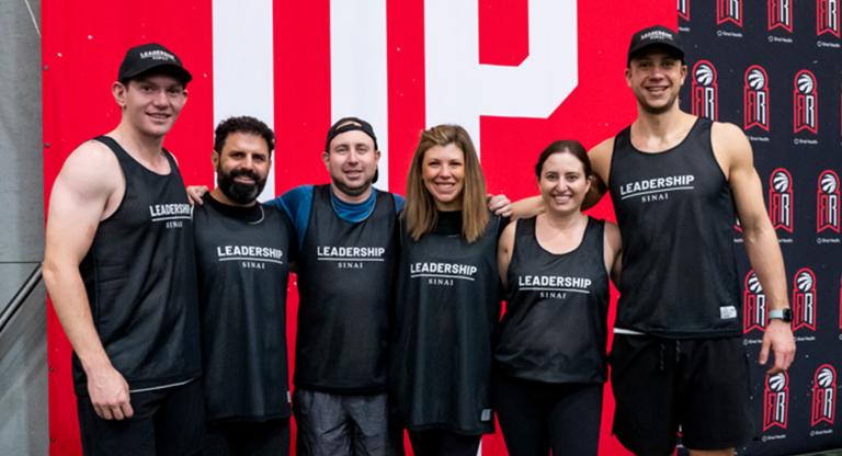 Group of people in athletic clothes posing for a group photo