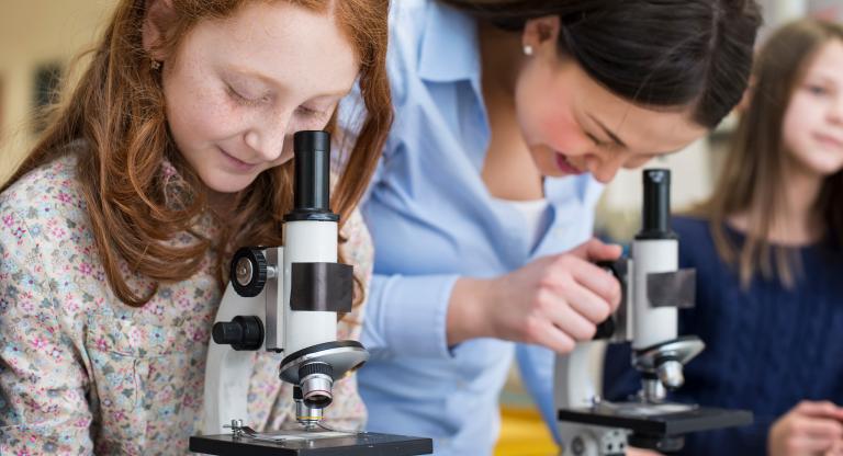 Children looking through microscopes