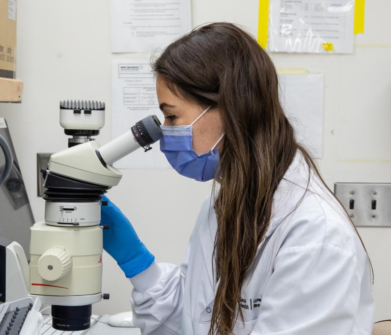 Looking through a microscope in a LTRI lab